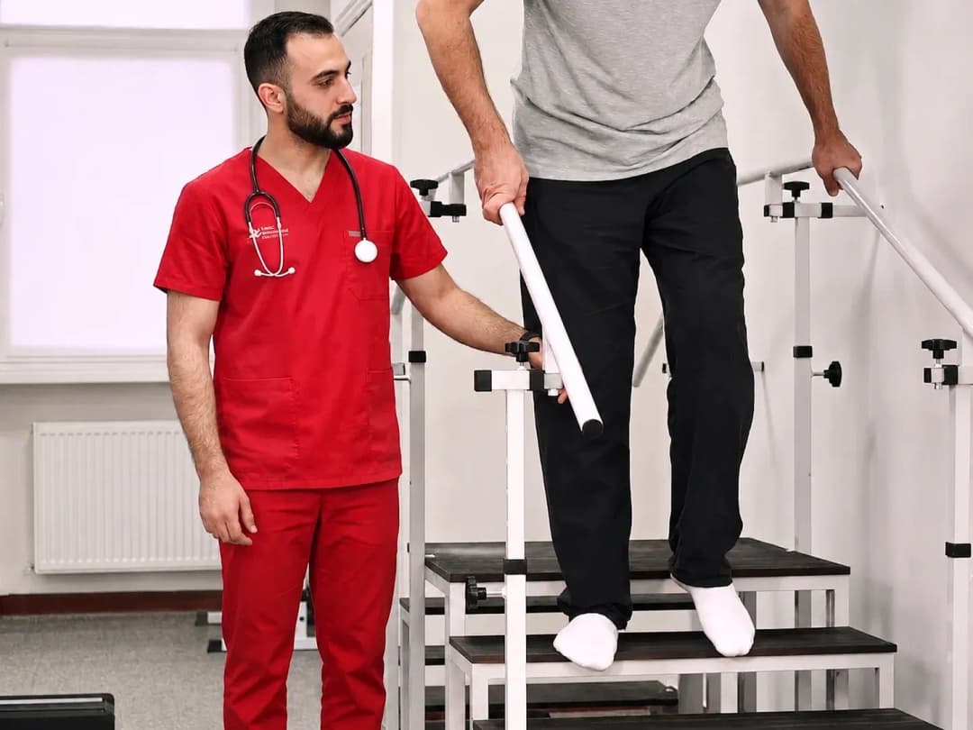 Nurse assisting a patient with walking rehabilitation during a home nursing visit in Riyadh