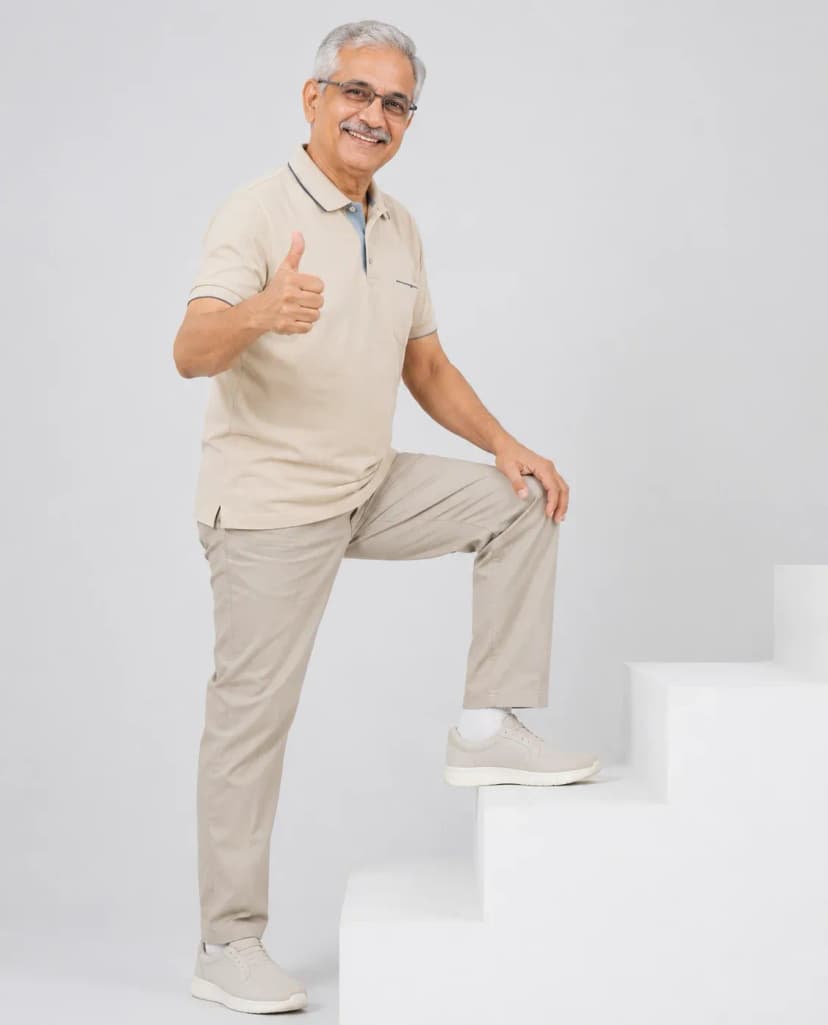 Senior man climbing stairs with confidence after physiotherapy for knee pain in Dubai