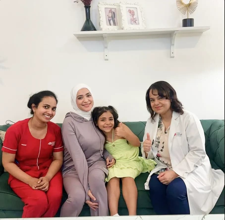 First Response Healthcare pediatrician posing with a young patient and family after a home visit in Dubai