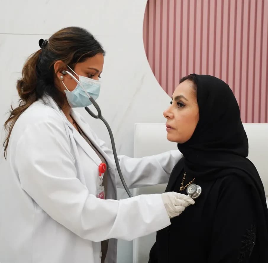 DOH-licensed doctor examining a patient during a home visit in Abu Dhabi