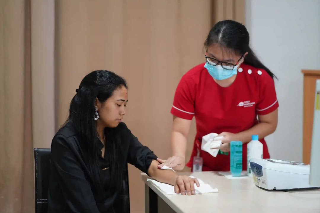 First Response Healthcare nurse collecting a blood test sample from a patient at home in Dubai