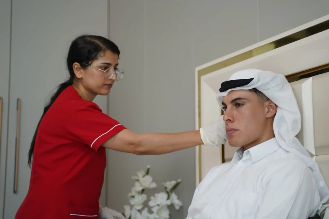 First Response Healthcare nurse examining a patient during a blood test home visit in Dubai