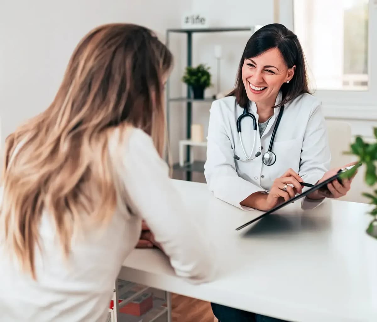 Doctor performing health assessment and diagnostics for patient at home