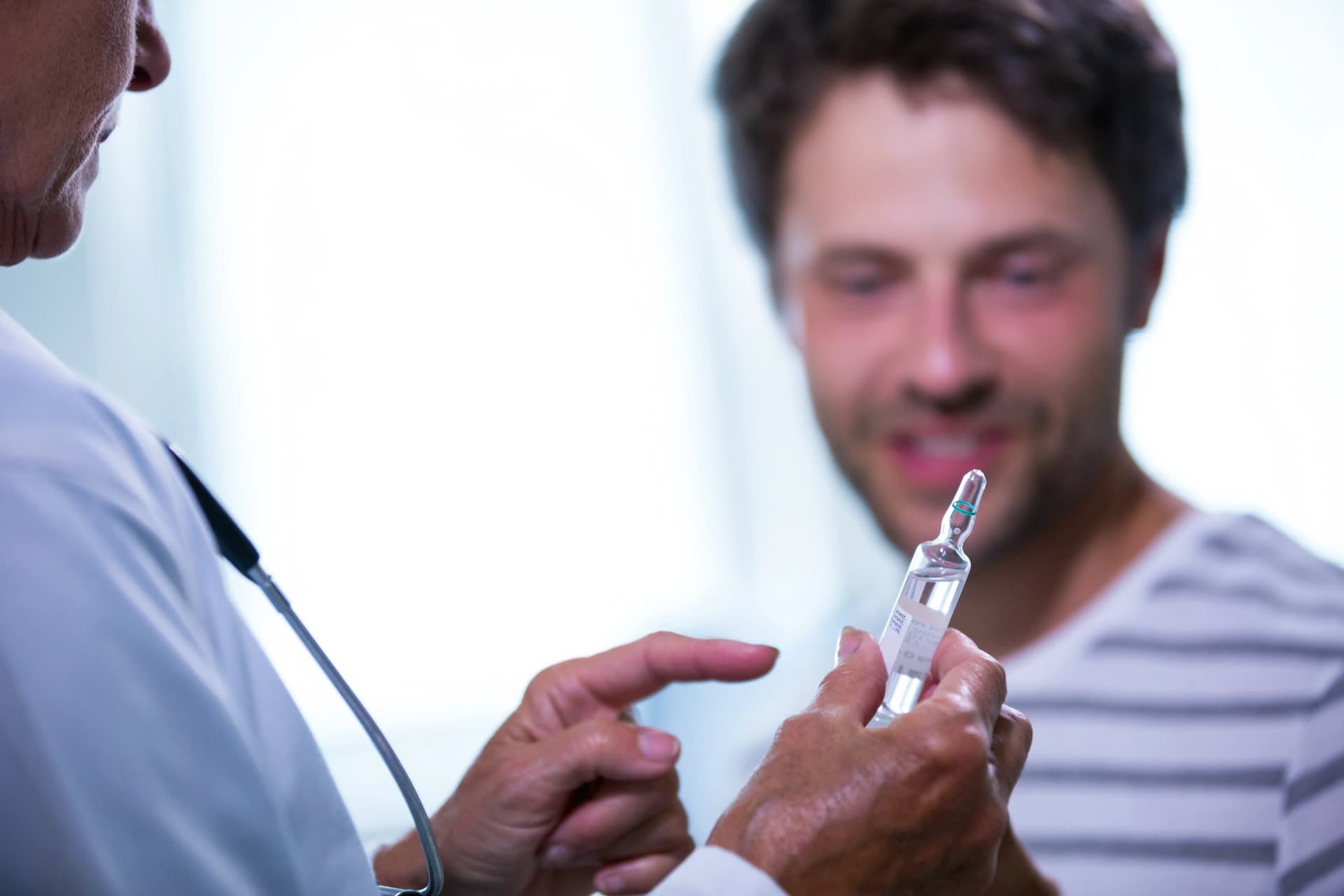 Doctor showing IV Drip to patient