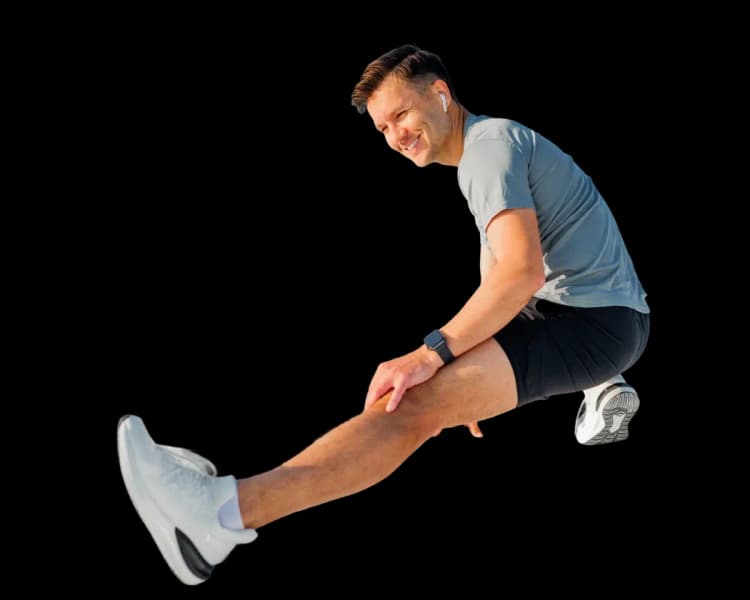 An athlete practicing mobility and flexibility exercises as part of home-based sports injury rehabilitation.