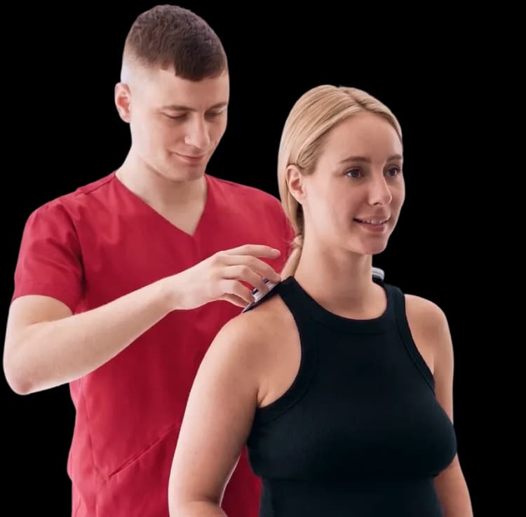 Male physical therapist applying manual mobilization techniques to a woman's shoulder for frozen shoulder treatment in Dubai.