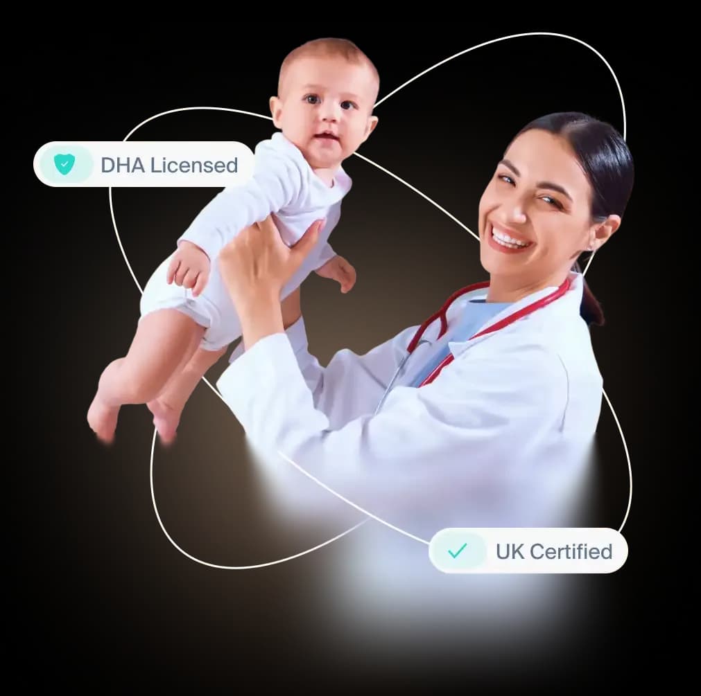 DHA-licensed, UK-certified pediatrician holding a baby during a home care visit in Dubai