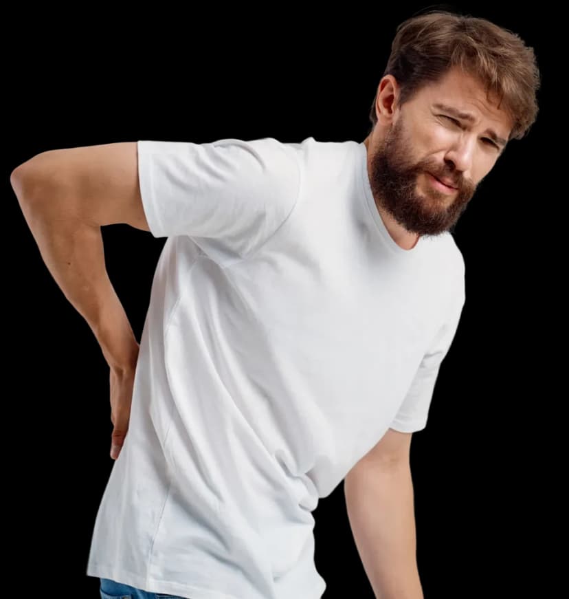 A man suffering from back pain holding his lower lumbar region, highlighting candidates who need neurological physiotherapy at home in Dubai.