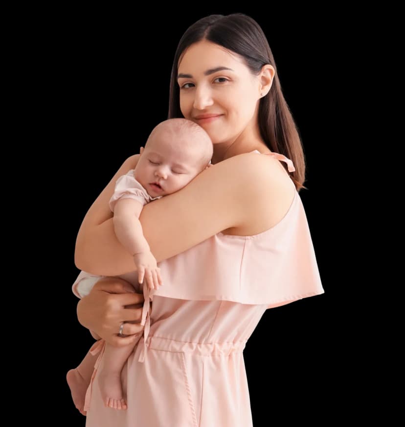 A happy mother holding her newborn baby at home, highlighting the benefits of pre and post natal physiotherapy in Dubai.