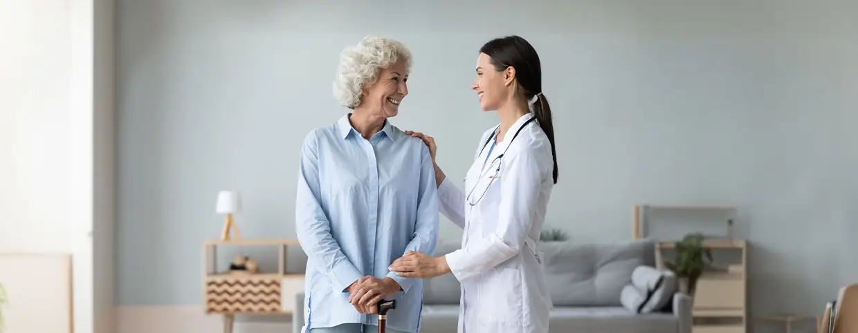 Doctor standing with a stethoscope smiling