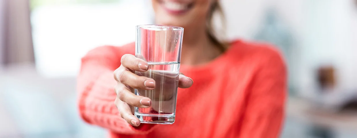 person holding a glass of water