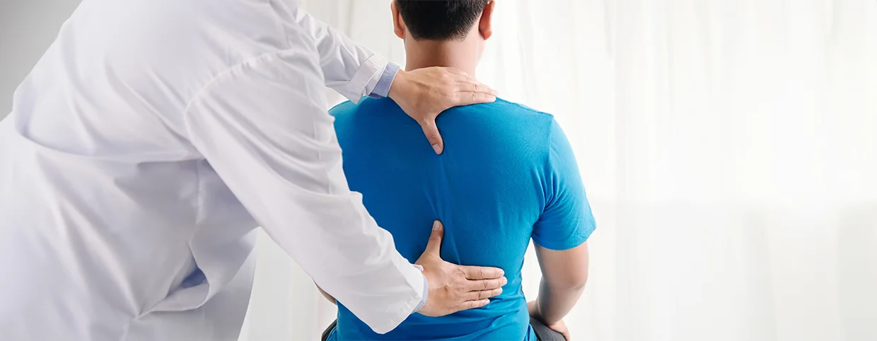 Doctor providing therapy to a man with herniated disc pain