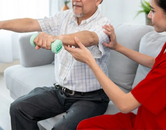 Physiotherapist helping a Senior patient to manage Chronic Pain in Dubai