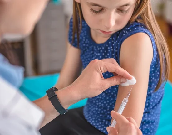 Young girl getting an injection to prevent common childhood illness