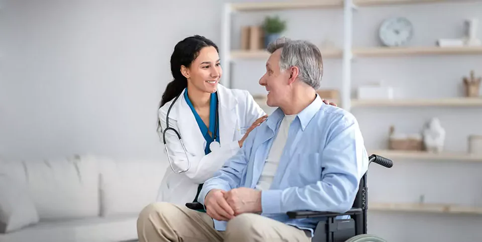 Doctor and senior patient both smiling warmly at each other