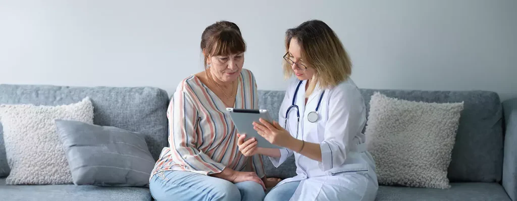 Doctor showing medical information to a woman on a phone