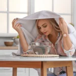 Woman inhaling steam for cold relief