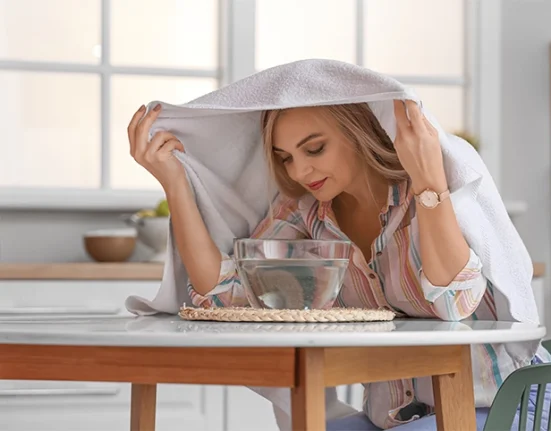 Woman inhaling steam for cold relief