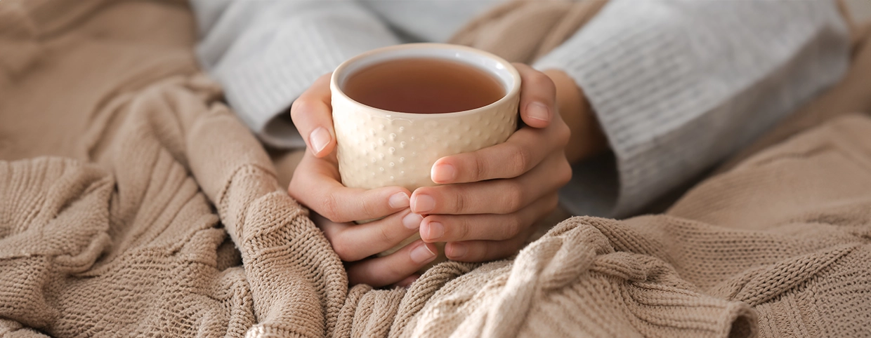 Women holding a warm cup of tea for cold relief