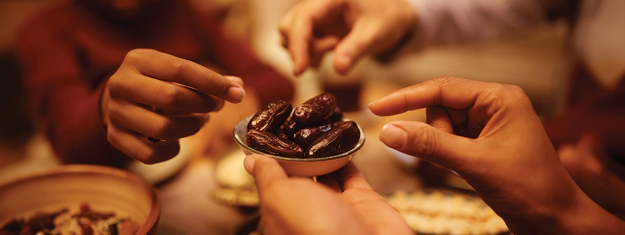 A group of people sharing dates a part of a healthy Ramadan meal plan