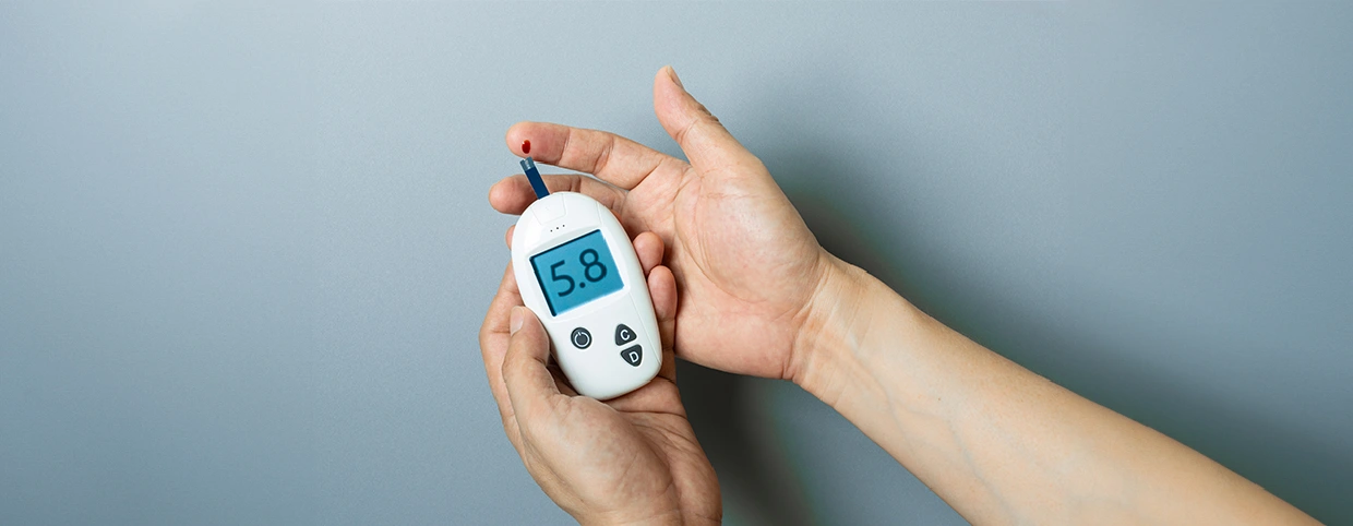 Patient testing blood sugar levels with a glucometer