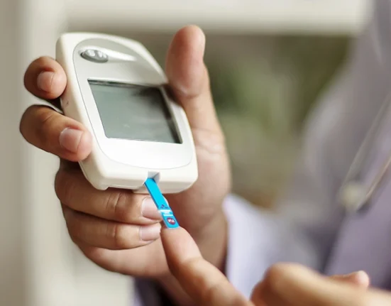 Patient undergoing a blood sugar level test