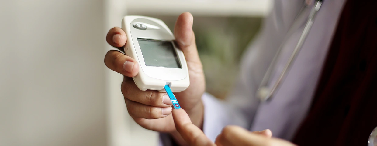 Patient undergoing a blood sugar level test