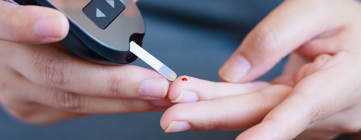 Patient performing a blood sugar level test