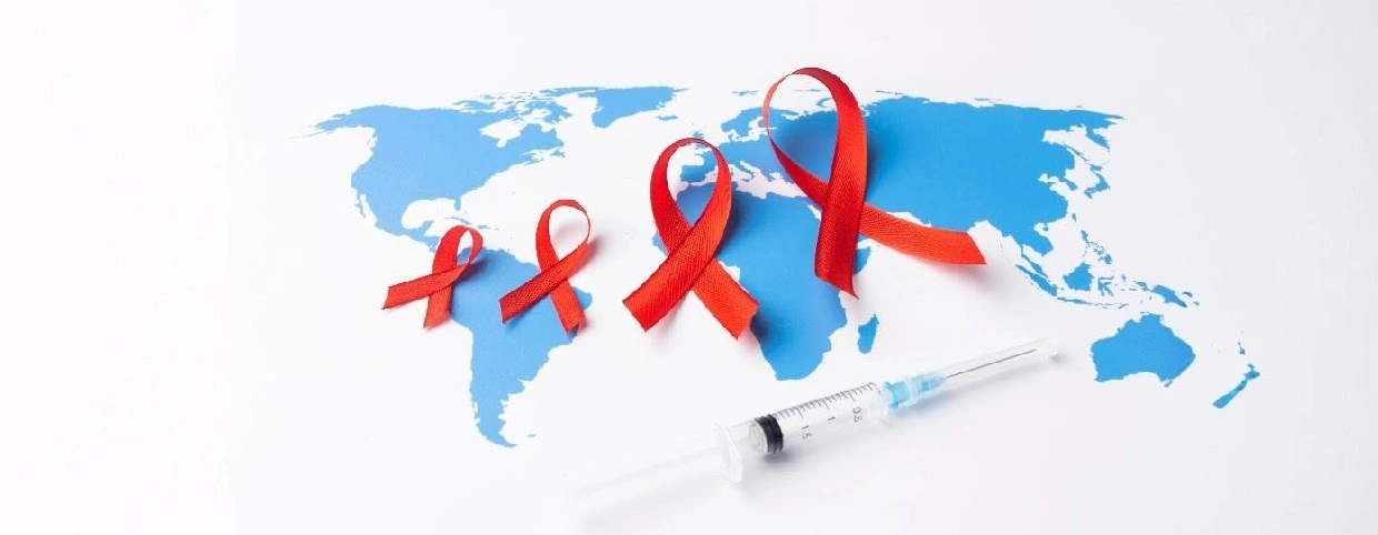 A word map with three red ribbon and a syringe symbolizing AIDS awareness