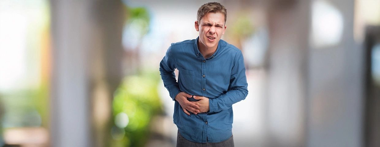 Boy holding his abdomen in discomfort or pain
