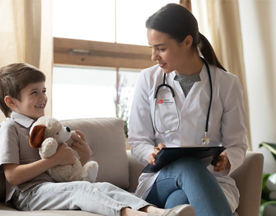 Pediatric doctor with reports in hand, talking to the child